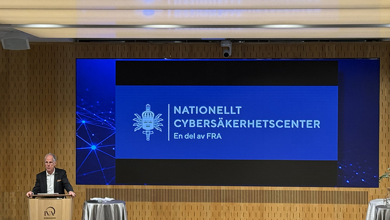 Man talar vid bild på NCSC:s logotyp